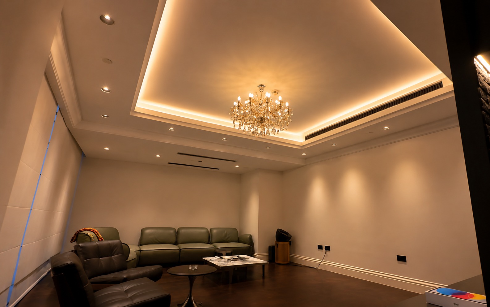 Majlis lounge with a crystal chandelier and perimeter cove lighting